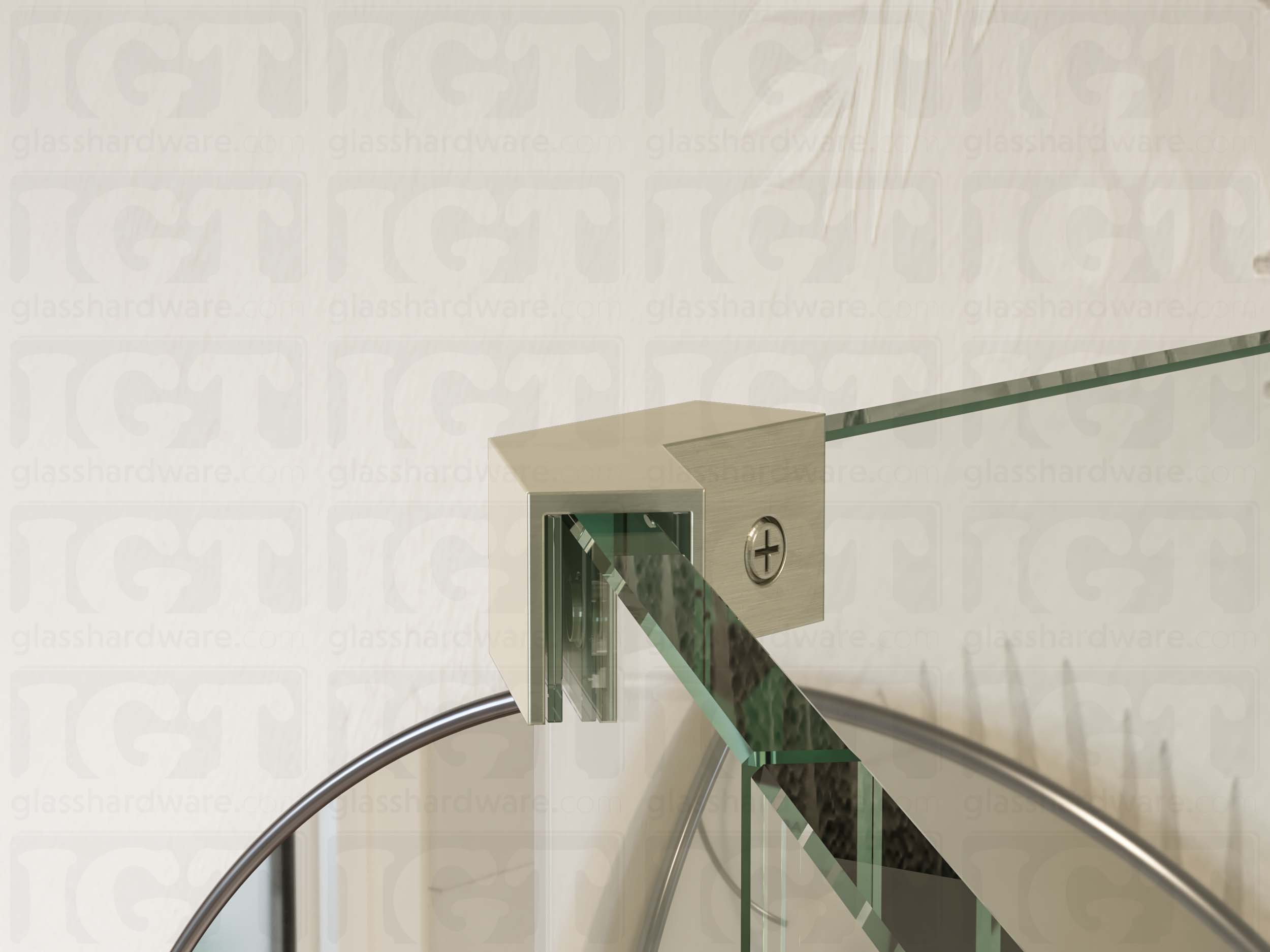 A close up view of the Glass-to-Glass 135 Degree Sleeve Over Clamp installed between two panels. A protective clear gasket rests between the clamp and glass panel. Brushed Nickel.