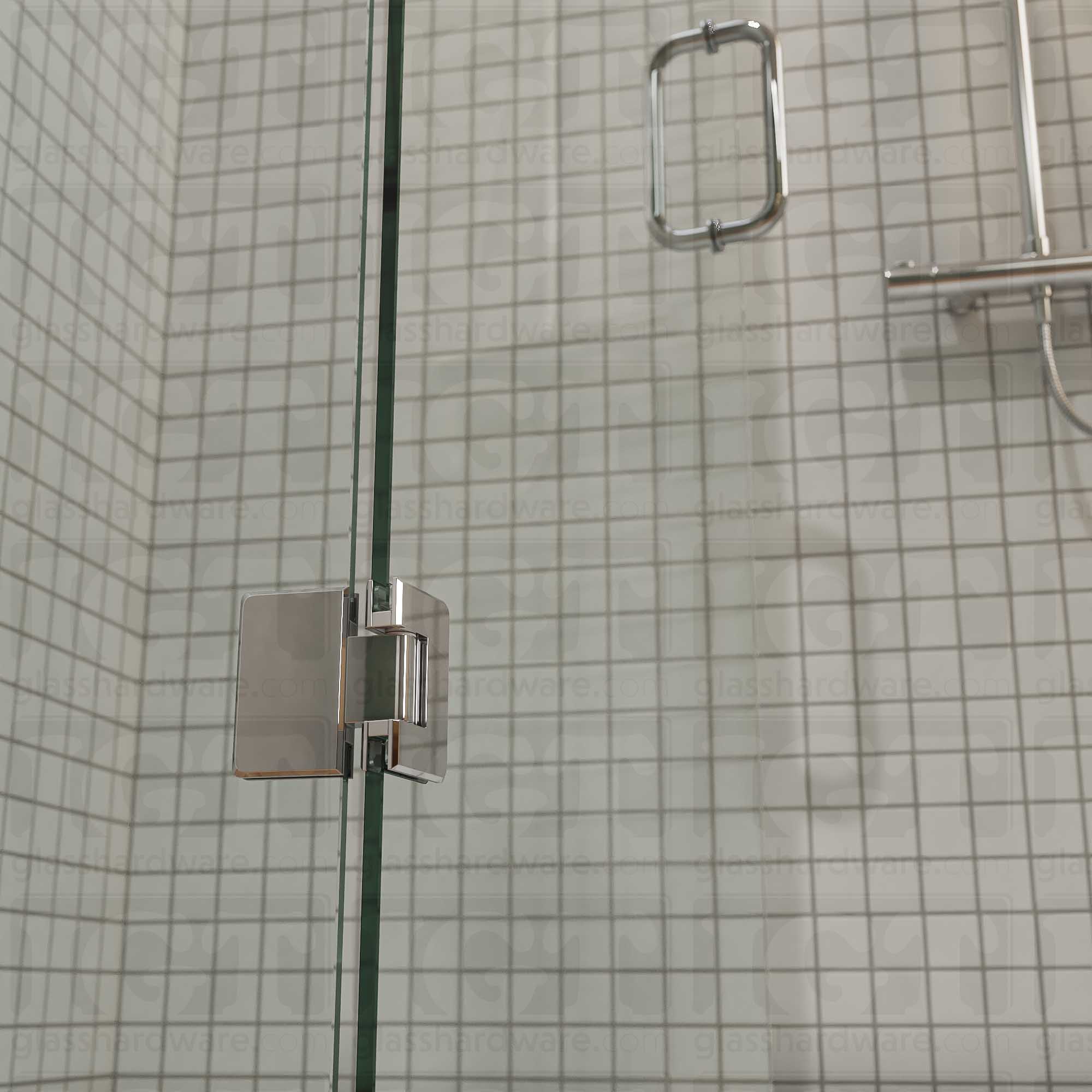 A close-up view of the bottom Glass-to-Glass 180 Degree Bilboa Hinge installed on a modern shower door in the open position. Chrome Polished.