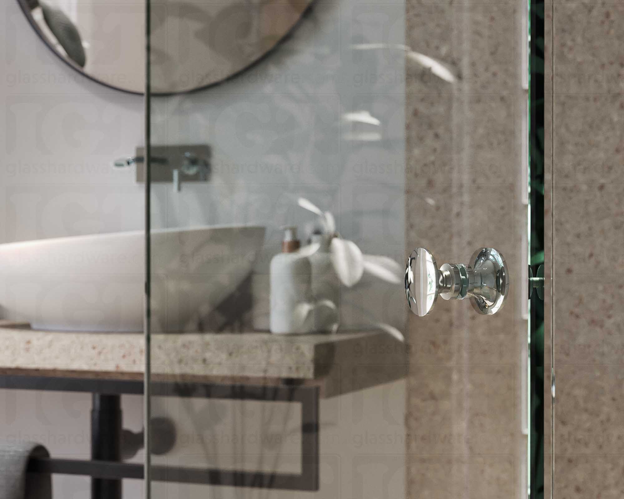 A close up of the Traditional Style Back-to-Back Door Knob installed on a glass shower door. The door knob's back-to-back design is tightly secured to the glass door. Chrome Polished.