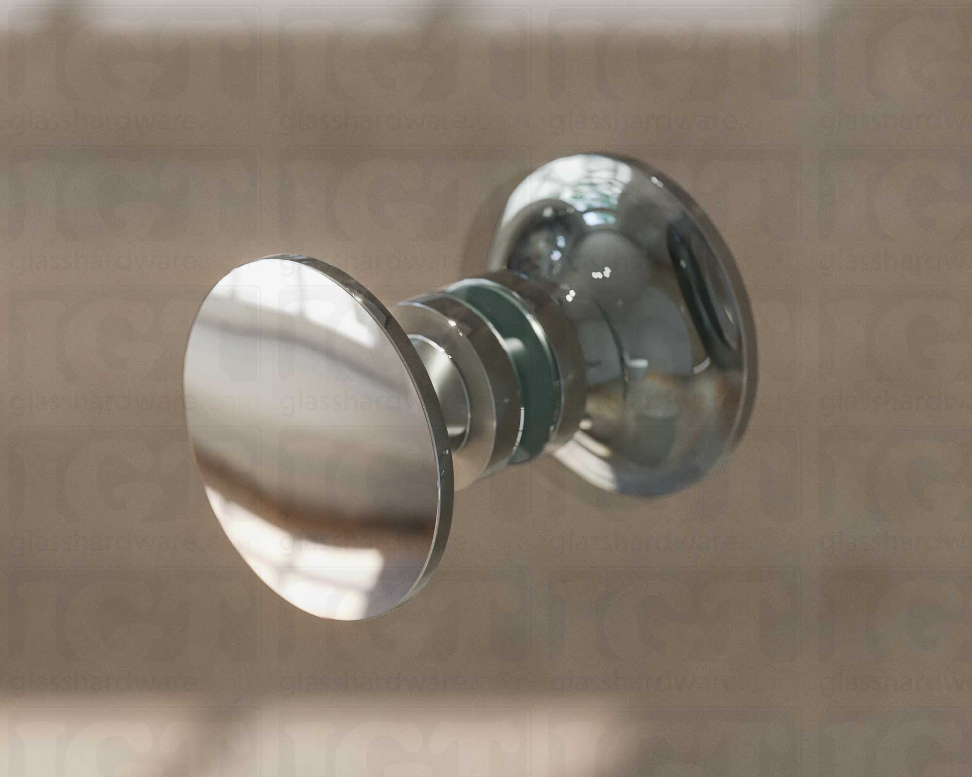 A close up of the Traditional Style Back-to-Back Door Knob installed on a glass shower door. Soft natural light highlights the knob's Chrome Polished finish.