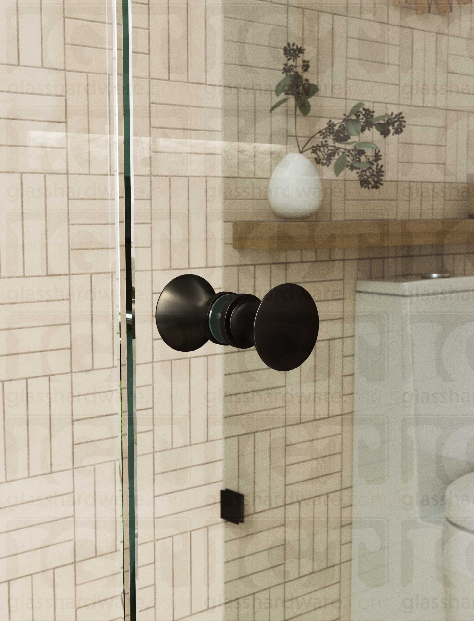 A close up of the Junior Traditional Back-to-Back Door Knob installed on a glass shower door. The door knob's back-to-back design is tightly secured to the glass door. Oil Rubbed Bronze.