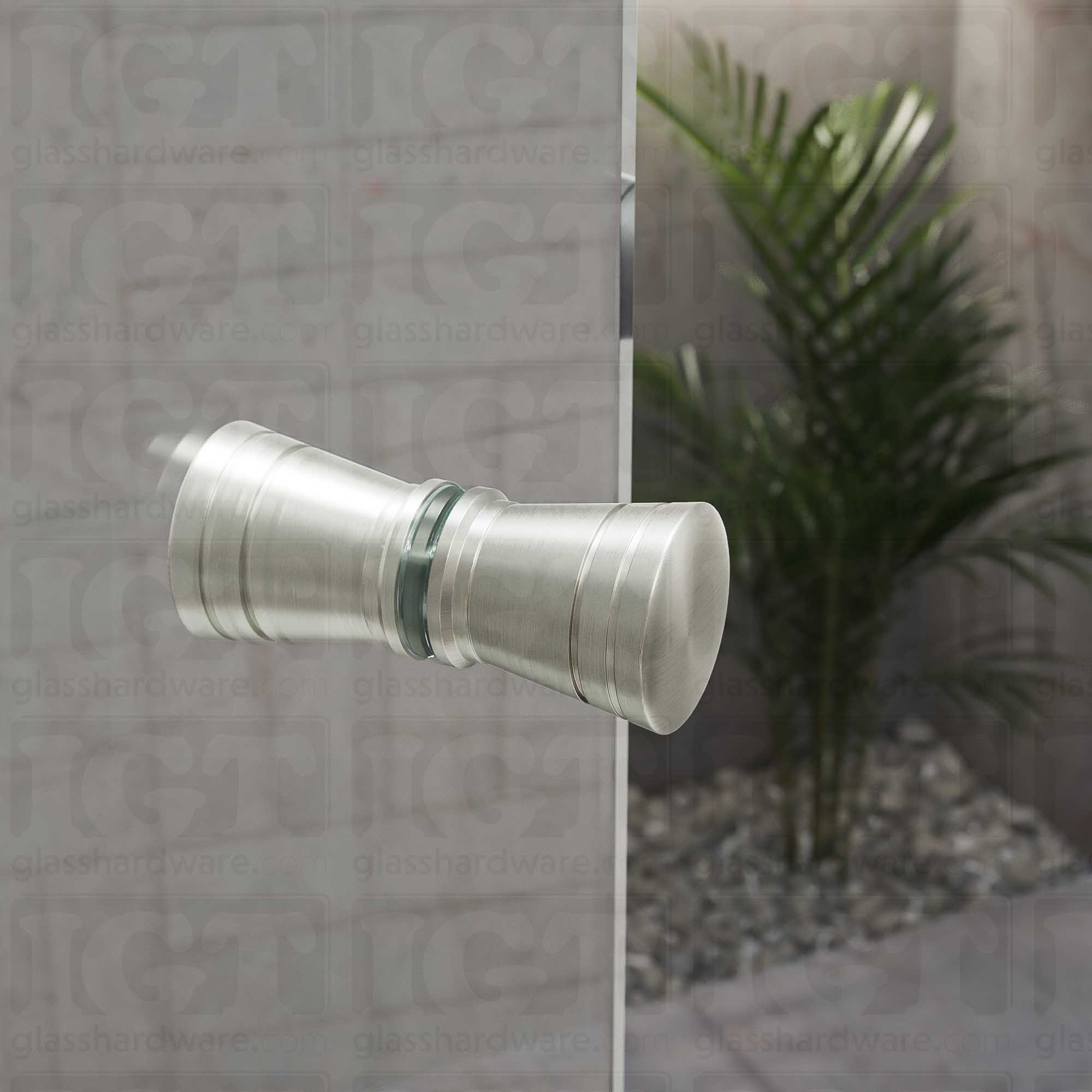 A close up of the Modern Ribbed Bow Tie Back-to-Back Door Knob installed on a glass shower door. The door knob's back-to-back design is tightly secured to the glass door. Brushed Nickel.