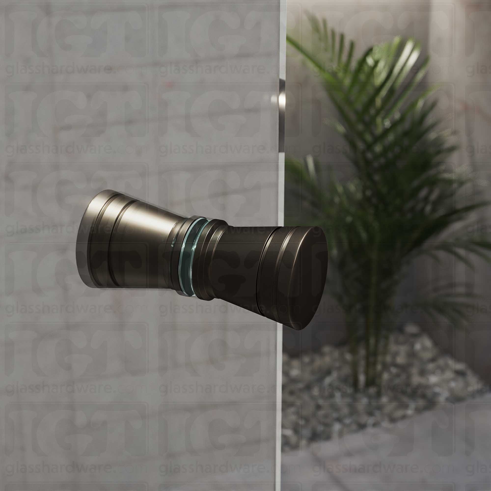 A close up of the Modern Ribbed Bow Tie Back-to-Back Door Knob installed on a glass shower door. The door knob's back-to-back design is tightly secured to the glass door. Oil Rubbed Bronze.