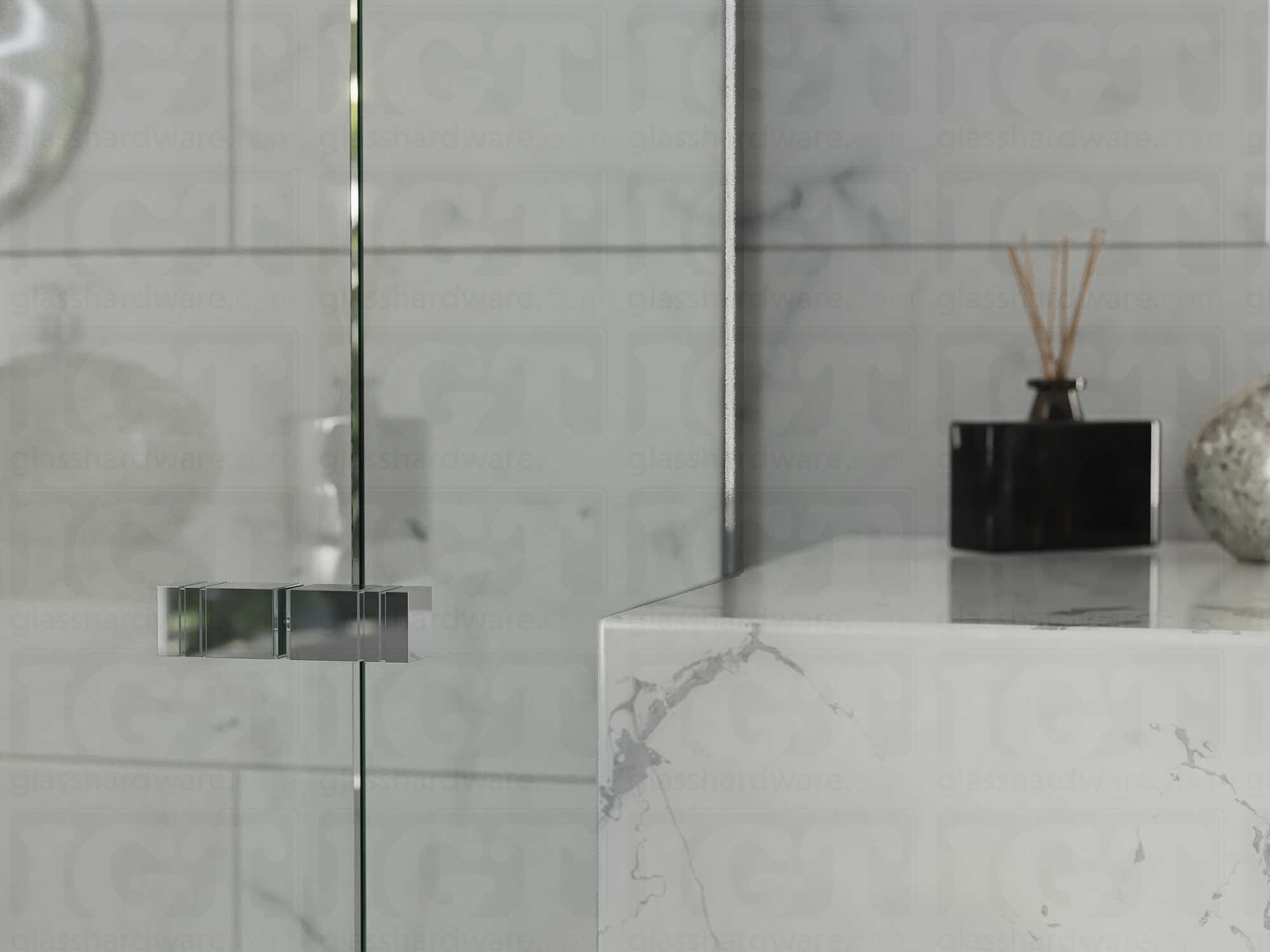 A close up of the Square Back-to-Back Door Knob installed on a glass shower door. Chrome Polished.