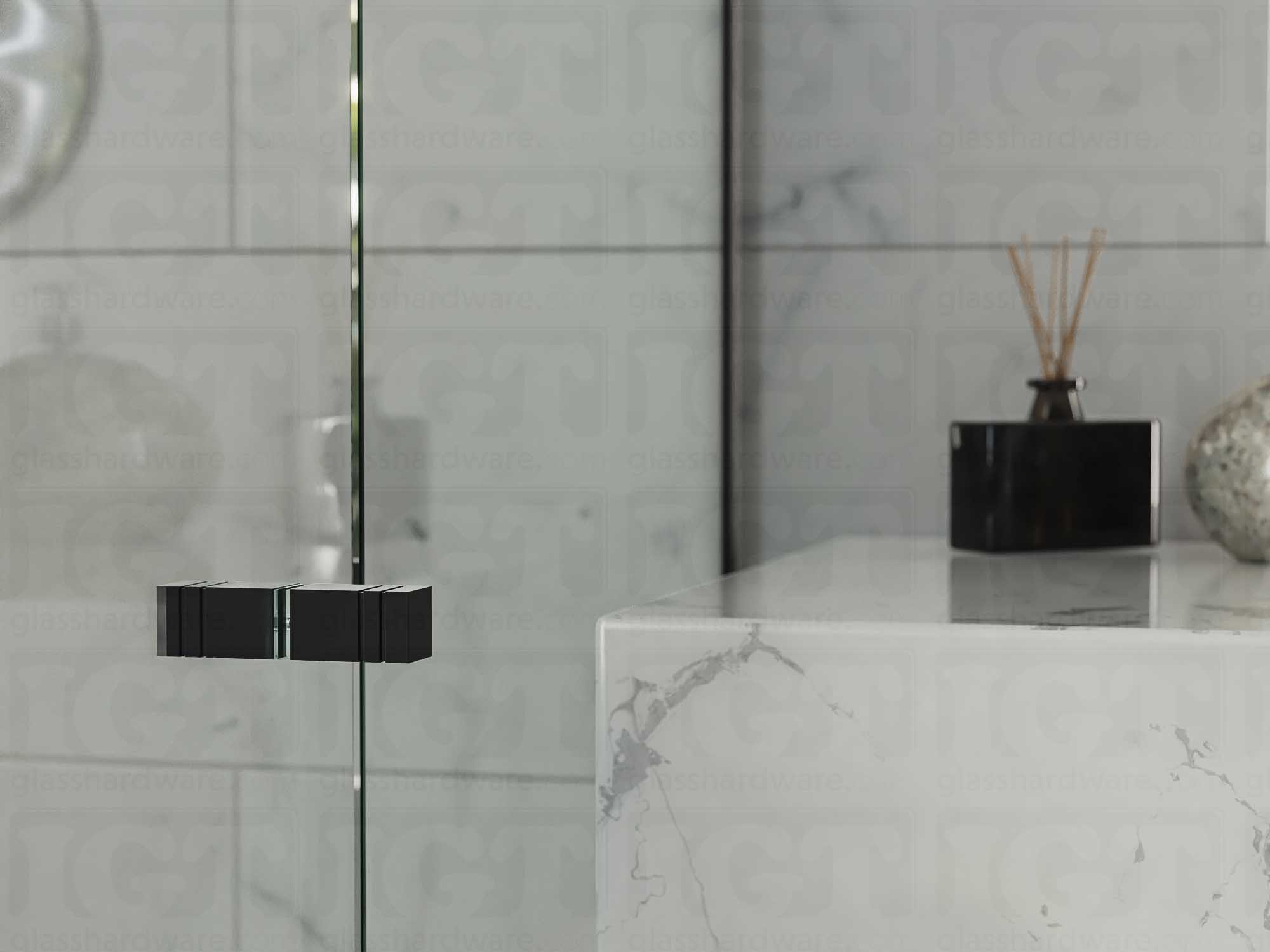 A close up of the Square Back-to-Back Door Knob installed on a glass shower door. Matte Black.