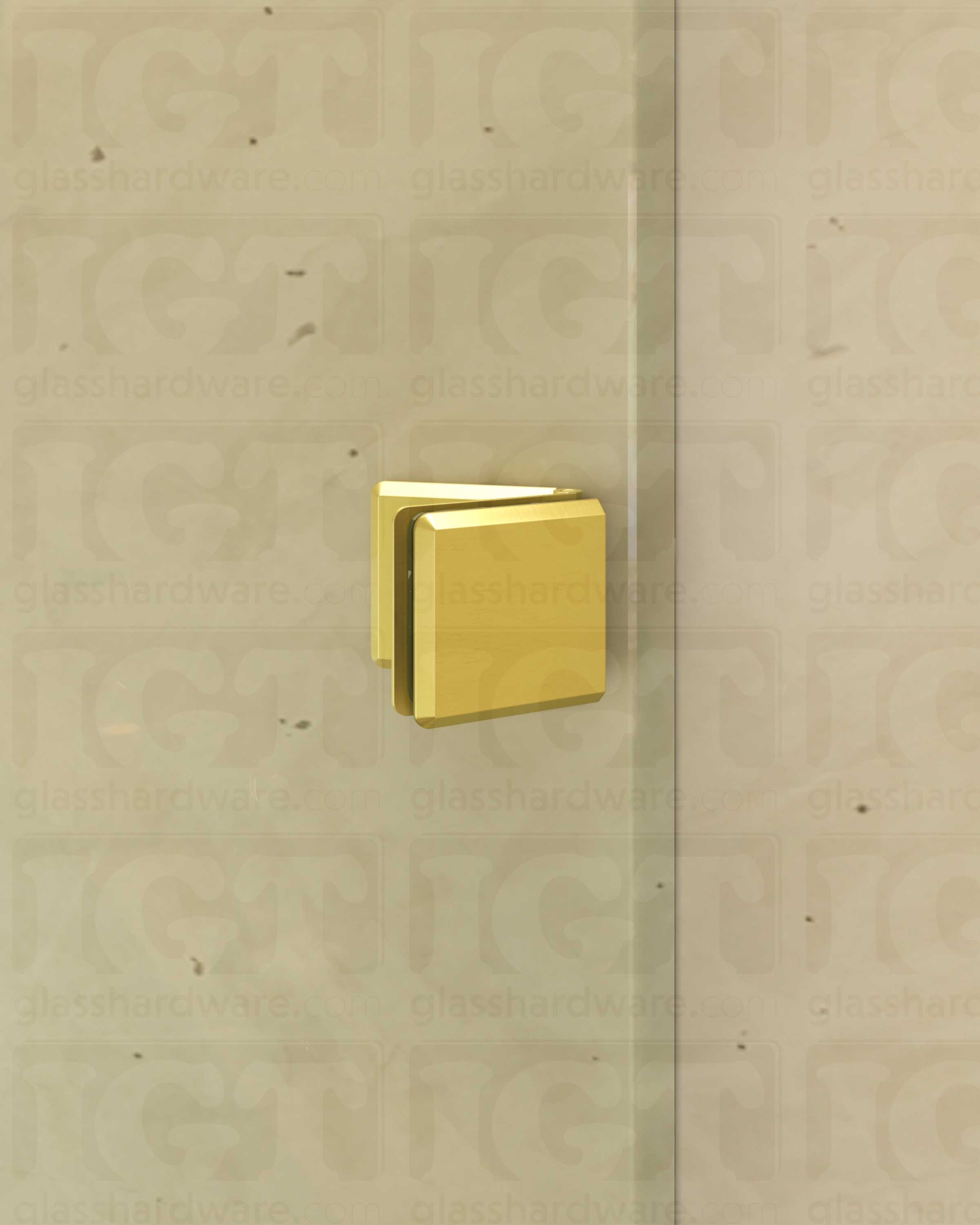 A close-up view of the Glass-to-Glass Adjustable Bilboa Clamp, installed on a shower enclosure. Gold Brushed.