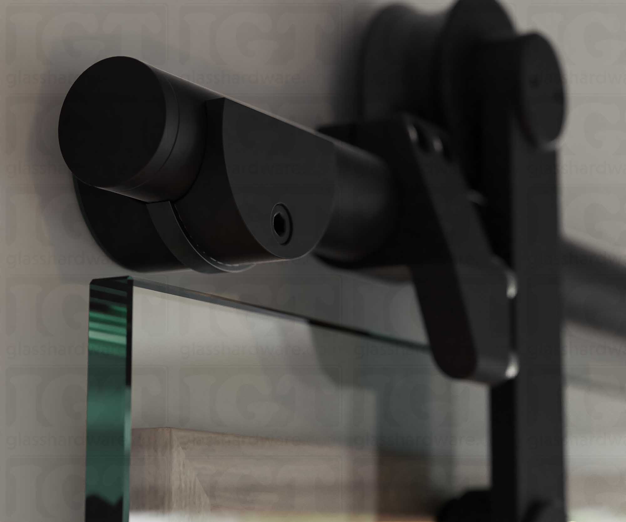 A close up of the Wall Mount Bracket, tightened to securely hold the barn door's upper track. Matte Black.