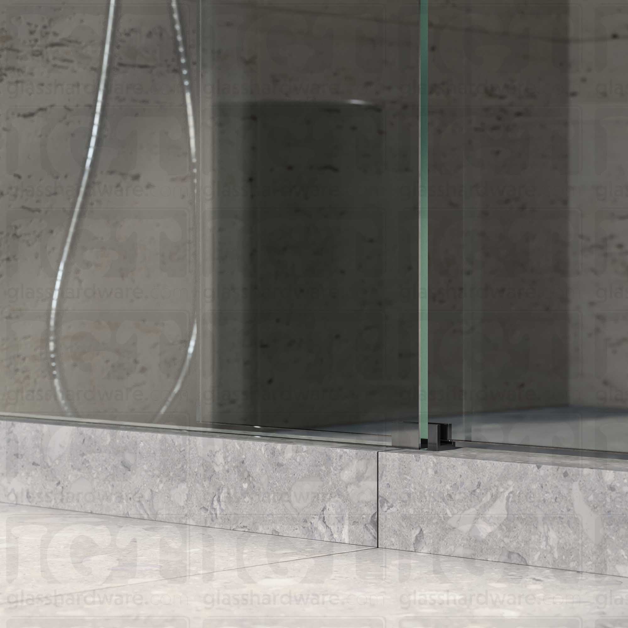 A close up of the Floor Guide for Modern Sliding System installed at the base of a glass sliding door. Polished Gun Metal.