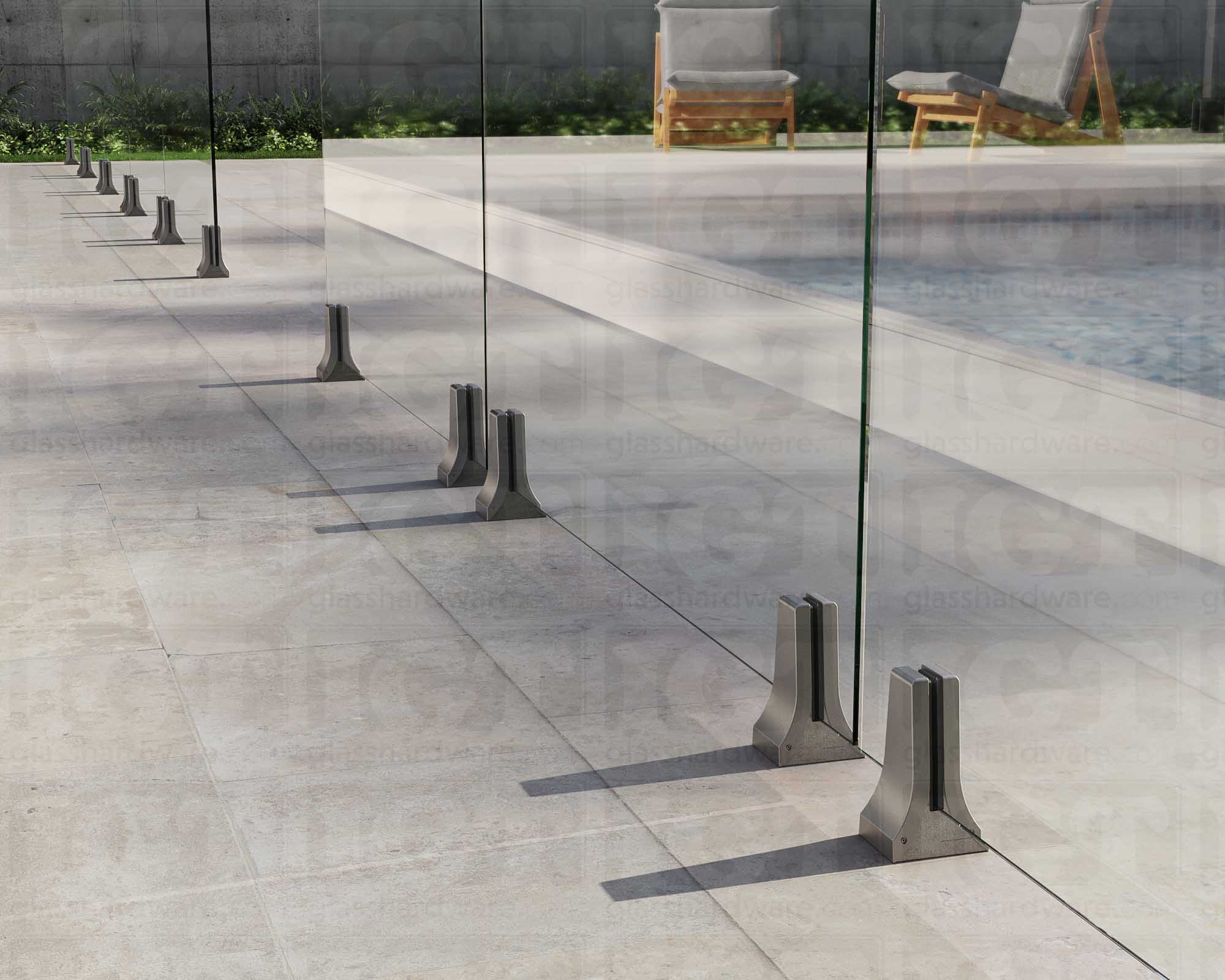 Several 316L Stainless Steel Chameleon Spigots installed to support a poolside glass railing system. Brushed Stainless.