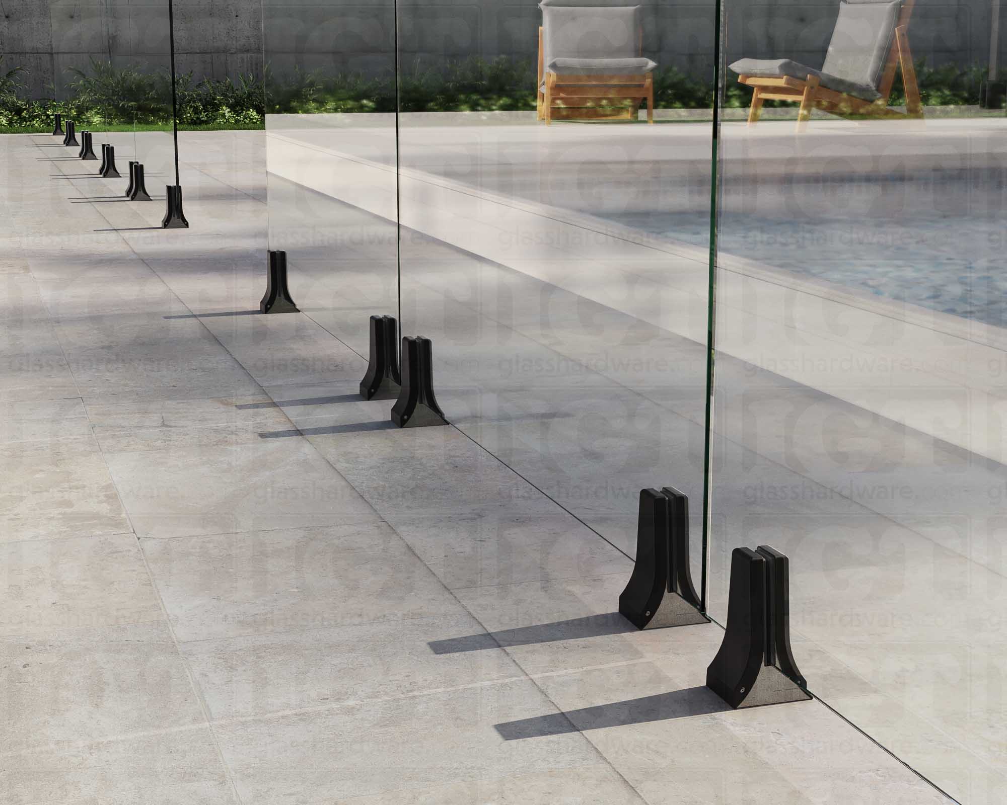 Several 316L Stainless Steel Chameleon Spigots installed to support a poolside glass railing system. Matte Black.