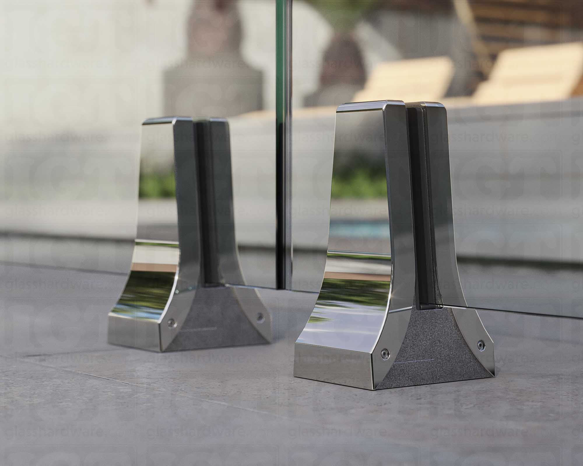 A close up of two 316L Stainless Steel Chameleon Spigots supporting a glass railing system. Polished Stainless.