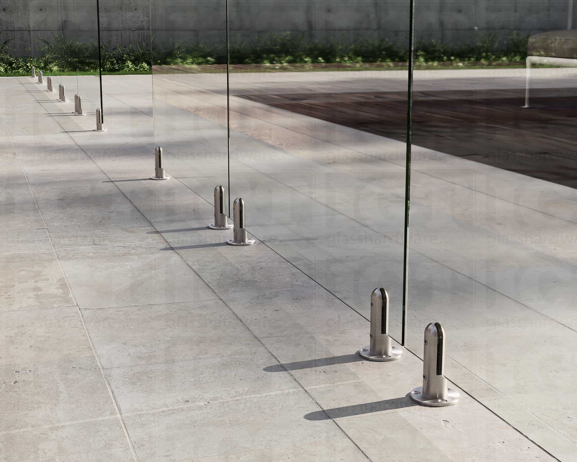 Several 316L Stainless Steel Round Spigots installed to support a poolside glass railing system. Brushed Stainless.