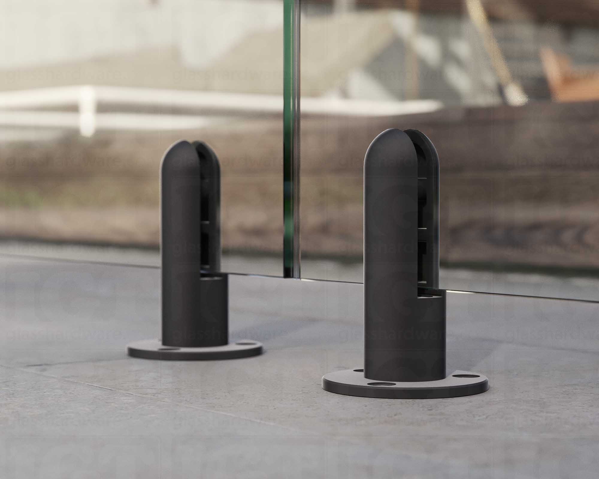 A close up of two 316L Stainless Steel Round Spigots supporting a glass railing system. Matte Black.