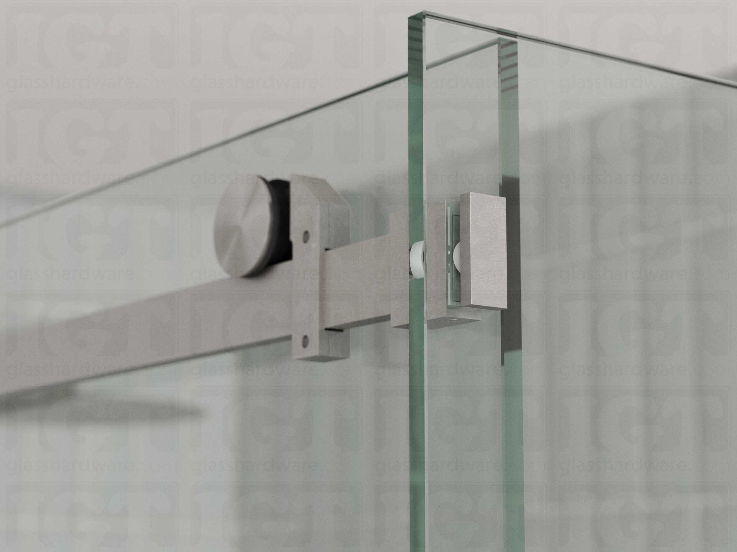 A close up view of the 90 Degree Connector fixed to the return panel and joined to the sliding door system's track. Brushed Stainless.