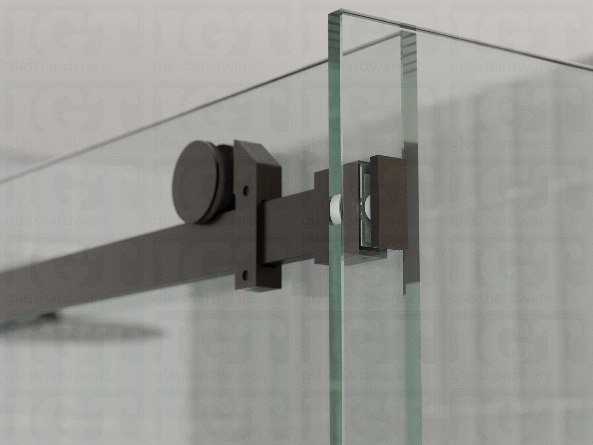 A close up view of the 90 Degree Connector fixed to the return panel and joined to the sliding door system's track. Oil Rubbed Bronze.