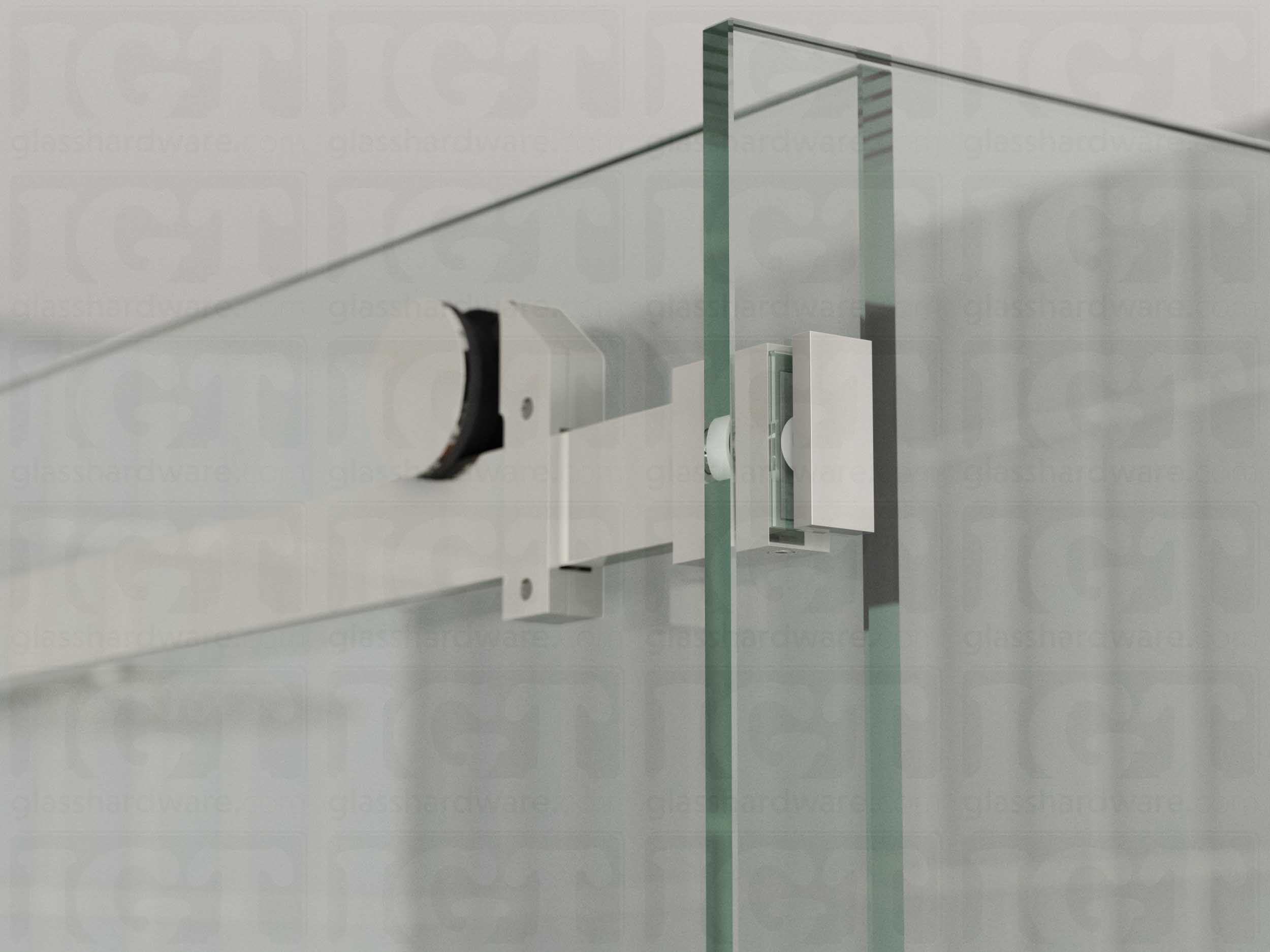 A close up view of the 90 Degree Connector fixed to the return panel and joined to the sliding door system's track. Polished Stainless.