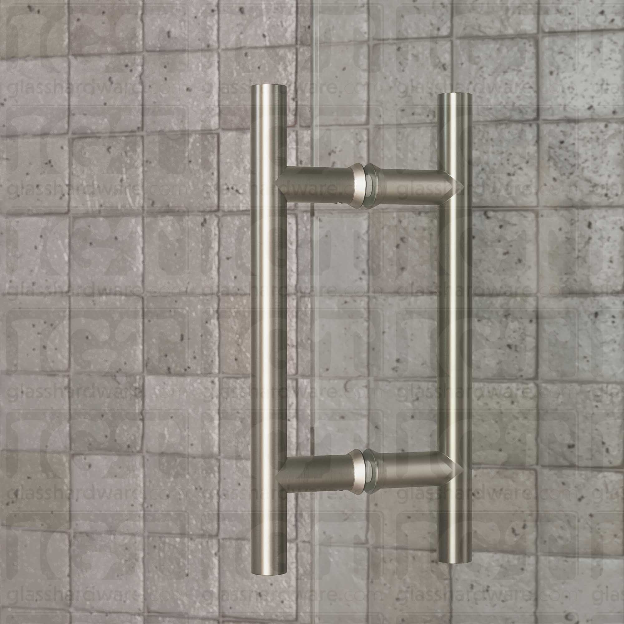 A close-up of the 6" Center-to-Center Round Ladder Handle installed on a glass shower door, showcasing its back-to-back design. Brushed Nickel.