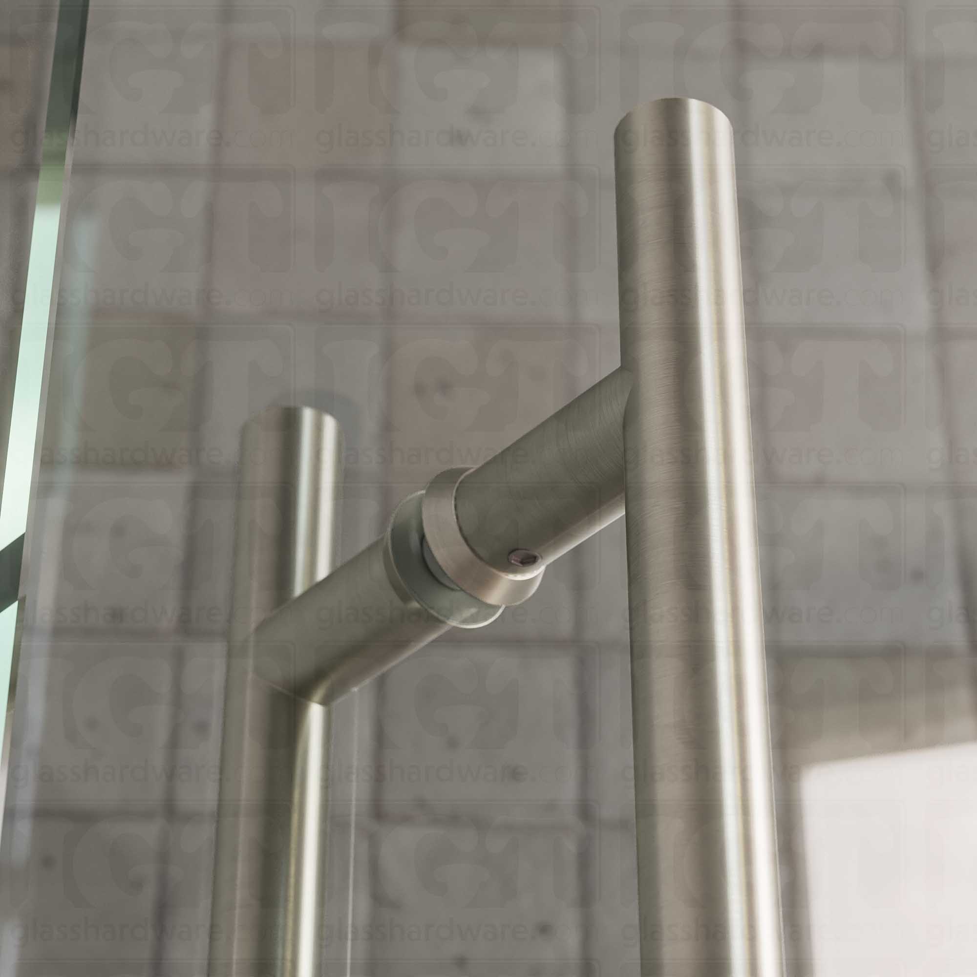 A close-up of the 6" Center-to-Center Round Ladder Handle installed on a glass shower door, showing its 304 Stainless Steel construction in more detail. Brushed Nickel.