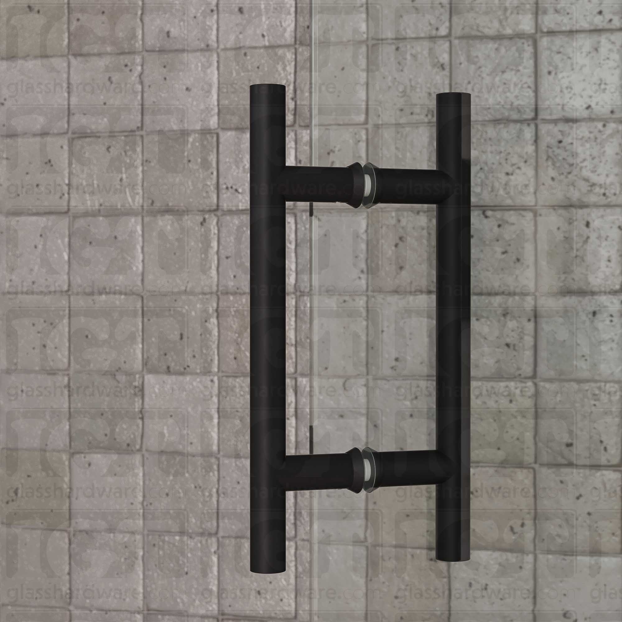 A close-up of the 6" Center-to-Center Round Ladder Handle installed on a glass shower door, showcasing its back-to-back design. Matte Black.