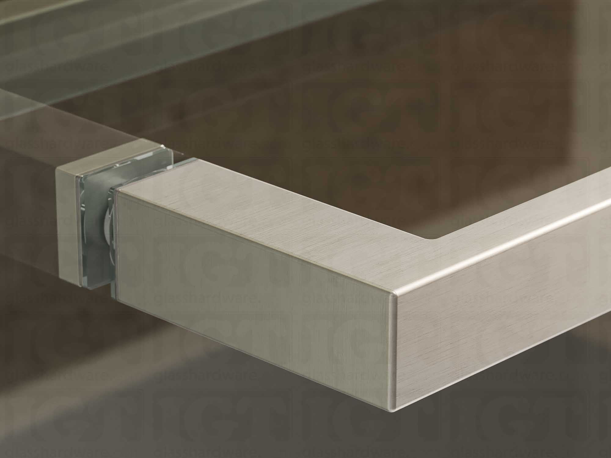 A close up of the 24" Slim Single-Sided Square Towel Bar installed on a glass sliding shower door showcasing its Brushed Stainless finish.