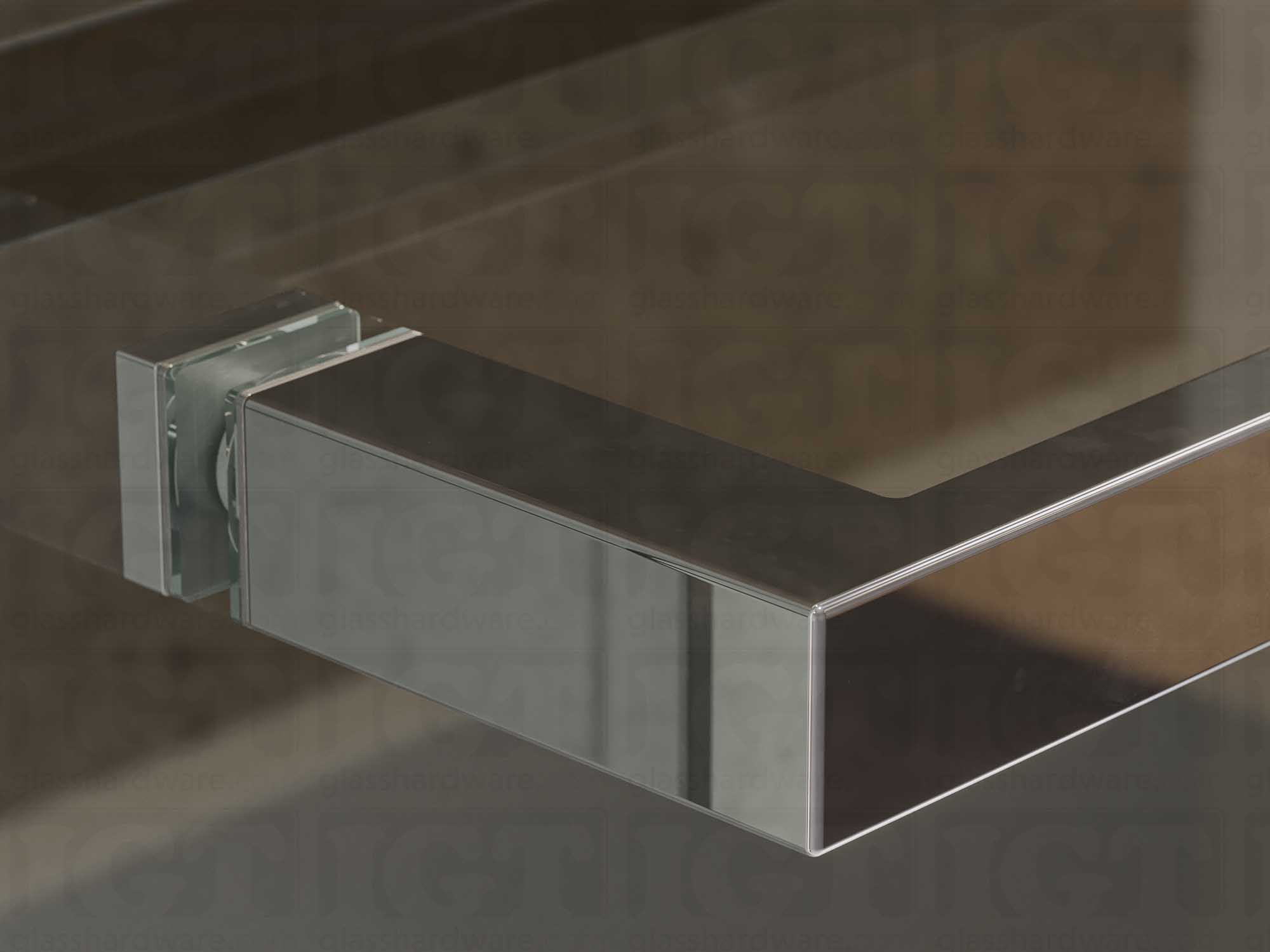 A close up of the 24" Slim Single-Sided Square Towel Bar installed on a glass sliding shower door, showcasing its Polished Stainless finish.