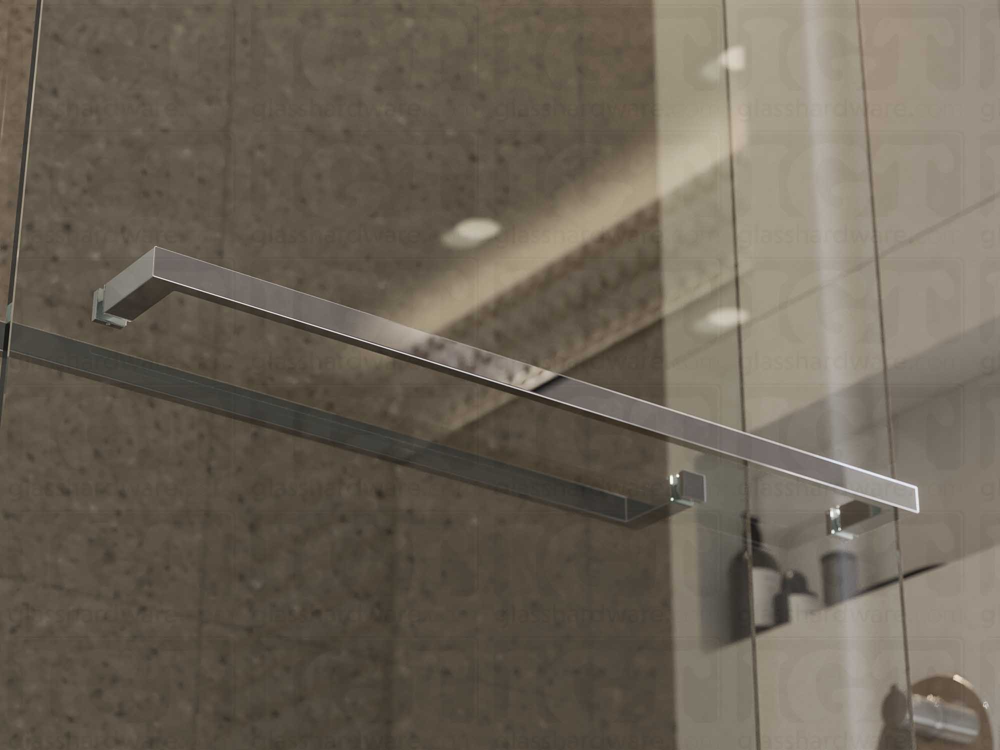 The 24" Slim Single-Sided Square Towel Bars installed on a glass shower door. Natural light reflects off its sleek Aluminum construction. Polished Stainless.