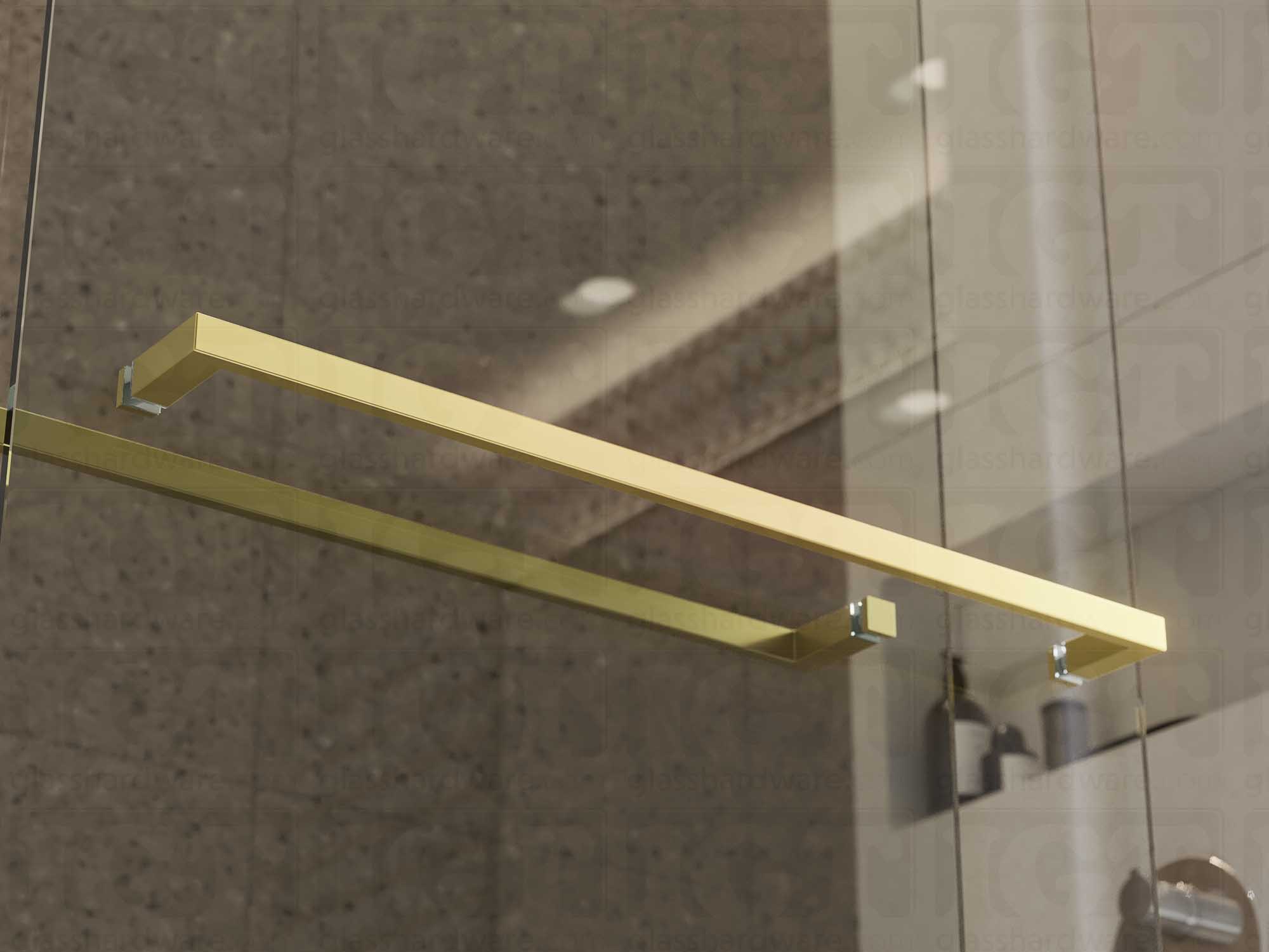 The 24" Slim Single-Sided Square Towel Bars installed on a glass shower door. Natural light reflects off its sleek Aluminum construction. Gold Brushed.