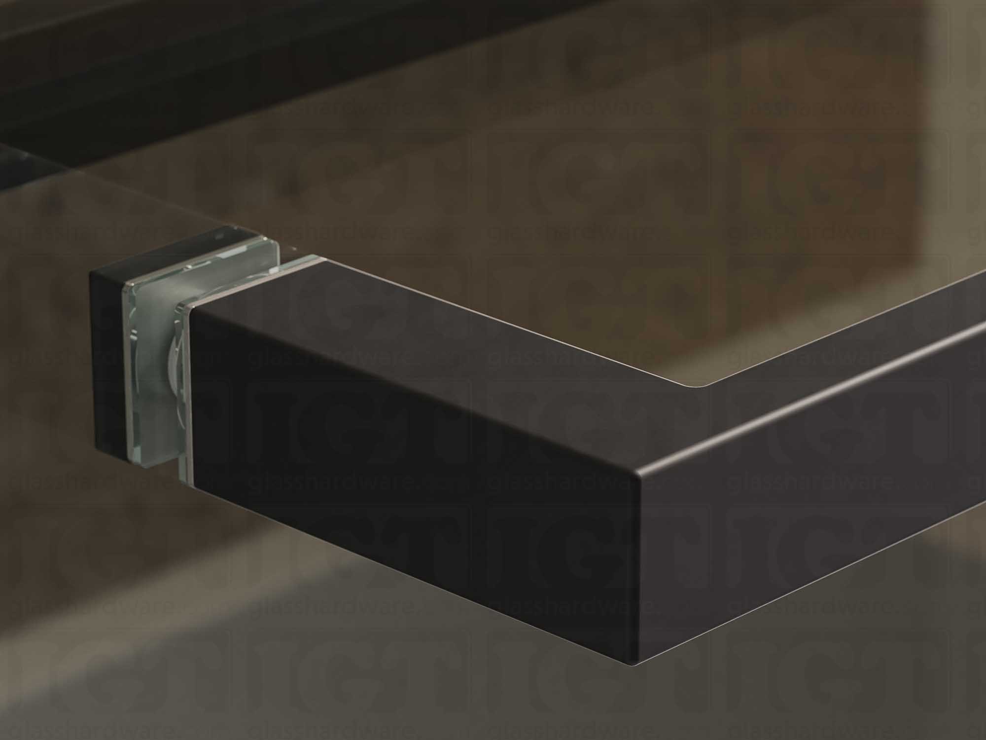 A close up of the 24" Slim Single-Sided Square Towel Bar installed on a glass sliding shower door, showcasing its Matte Black finish.